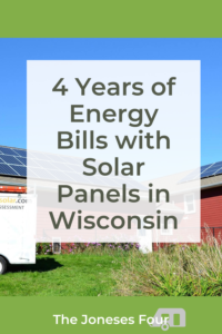Pinterest image for blog post titled "4 Years of Energy Bills with Solar Panels in Wisconsin" by The Joneses Four. Image includes a red building in the back ground and post title in a white box in dark grey text. Wild flowers are growing in the front and a work trailer is shown off to the side. 